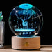 Luminous crystal ball with galaxy-inspired deer motif and wooden base, illuminating room with magical celestial light, ideal for stargazers.