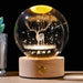 Starry Sky Luminous Ornaments Universe Galaxy Crystal Ball with glowing deer on wooden base, creating celestial light patterns