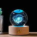 Starry Sky Luminous Ornaments Universe Galaxy Crystal Ball glowing with celestial light on a wooden base.